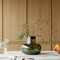 Green Glass Vase with Floral Branches on White Table Wooden Wall Background