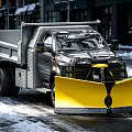 Heavy Duty Dump Truck Equipped With Yellow Snow Plow Clearing Snowy Urban Street