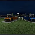Favorware Outdoor Vehicle Display With Orange And Blue Cars Showcased On Grass Field At Sunset