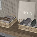 Set of Woven Storage Baskets with Folded Linens and Rolled Towels on Wooden Countertop
