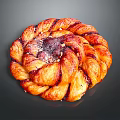 Delicious Swirled Braided Pastry With Red Berry Filling Glazed Surface And Toasted Nut Sprinkles