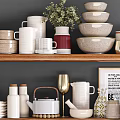 Stylish Kitchenware Display On Wooden Shelves With Bowls Mugs Teapot Plates And Decorative Plant