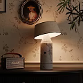 Marble Table Lamp With Beige Lampshade And Vintage Radio On Floral Wallpaper Background