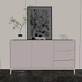 Modern White Entryway Console Cabinet with Framed Artwork Green Plant and Black Figurine