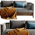 Grey Two Seater Sofa with Wooden Frame Orange Blanket and Blue Cushions