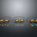 Three Gold Eyeglasses Adorned With Green Gemstones On Black Background Reflections