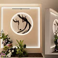 Floral Art Display With Circular Decorative Painting Lighted Backdrop Wall Various Flowers And Green Plants