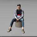 A Man Sitting On Cylindrical Stool Wearing Black Cap Gray Jacket And Blue Jeans