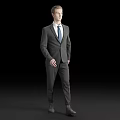 Man Walking in Formal Gray Suit With Blue Tie Against Black Background