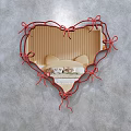 Heart Shaped Mirror with Red Ribbon Bow Frame Reflecting Bedroom Interior and Wooden Walls