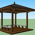 Outdoor Wooden Pavilion With Black Roof Benches And Table In Green Landscape Under Blue Sky