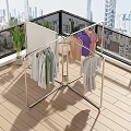 Modern Metal Clothes Rack With Hanging Garments And Green Plants On Terrace Wooden Floor