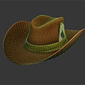 Orange Cowboy Hat With Yellow Band And Decorative Emblem On Gray Background