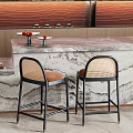 Modern Bar Counter With Marble Top And Wicker Back Bar Stools With Orange Cushions