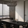 Minimalist Living And Dining Room With Dark Dining Table Rattan Chairs And Soft Natural Daylight