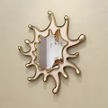 Decorative Mirror on Beige Wall with Irregular Sunburst Shaped Frame Reflecting Bedroom With Furniture