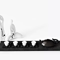 Modern Tea Set With Black Teapot Four White Teacups Black Tray And White Humanoid Figurines