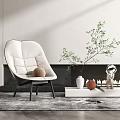 Modern White Accent Chair with Soft Cushions in Living Room with Green Plant and Fireplace
