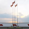 National Flags Flying On Flagpoles With Sunset Sky And Red Banners Below