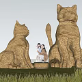 Giant Straw Cat Sculptures Art Installation In Grass Field With Blue Sky And People