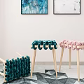 Green and Pink Woven Stools with Light Wooden Legs in Indoor Geometric Rug Setting