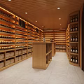 Modern Neat Wine Cellar With Wooden Racks Filled Wine Bottles Central Counter Light Strips