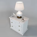 White Bedside Table With Table Lamp Alarm Clock Coffee Cup And Drawer With Gold Knobs 3d model