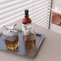 Whiskey Bottle and Crystal Glasses on Gray Tray with Minotti Decor and Window Blinds