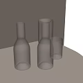 Transparent Glass Cups Three Different Shapes on Dark Round Tabletop with Light Colored Wall Background