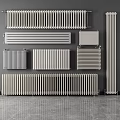 Various Styles of Modern Radiators Displayed on Gray Wall and Floor Surface