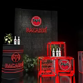 Bacardi Product Display Setup With Bottles Red Elements Speakers And Green Plants