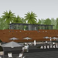 Boat Shaped Guesthouse Building Surrounded By Palm Trees With Outdoor Seating And Umbrellas