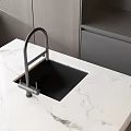 Modern Kitchen Faucet With Black Sink On White Marble Countertop And Gray Cabinets