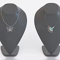 Butterfly And Leaf Pendant Necklaces With Green Accent On Display Stands