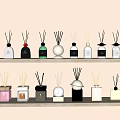 Stylish Fragrance Products Displayed On Wooden Shelves With Various Designs Colors And Reed Diffusers