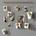 Creative Photo Wall With Family Photos And Art Prints Hanging On Strings