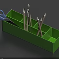 Pencils and Brushes in Green Pencil Case with Blue Scissors on Side