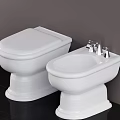 White Ceramic Toilet and Bidet with Chrome Faucets on Black Floor and Gray Wall