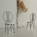 Single Chair with Black Round Backrest Woven Light Cushion in Minimalist Setting with Autumn Tree