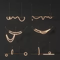 Modern Curved Line Chandeliers With Glowing Light Against Dark Background