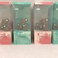 Four Pink And Green Claw Machines As Amusement Equipment Filled With Brown Stuffed Toys