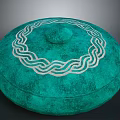 Green Circular Sculpture Carving With White Interlaced Pattern And Textured Surface