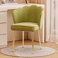 Green Scalloped Back Velvet Accent Chair With Gold Legs On Round Rug Beside White Dresser