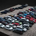 Parking Lot Full of Various Colored Cars And Different Vehicle Models Densely Parked