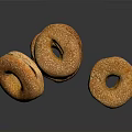 Golden Brown Sesame Seed Bagels Stacked and Single on Black Surface