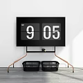 Black Flip Clock Showing 905 With Copper Stand Two Black Baskets White Wall Gray Floor