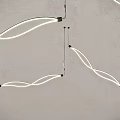 Modern Minimalist Curved White Chandelier With LED Strip Lights Mounted On Gray Wall Background