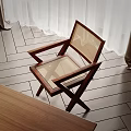 Modern Accent Chair With Wooden Frame And Rattan Seat On Herringbone Wood Flooring