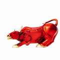 Red Bull Figurine With Shiny Surface And Golden Hooves On White Background