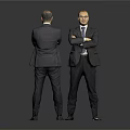 Two suited men one facing front with crossed arms and one behind against gray background